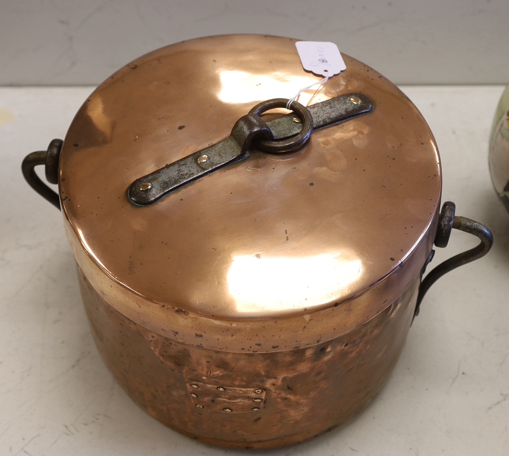 A French copper cooking pot and cover with swing handle, 27cm high